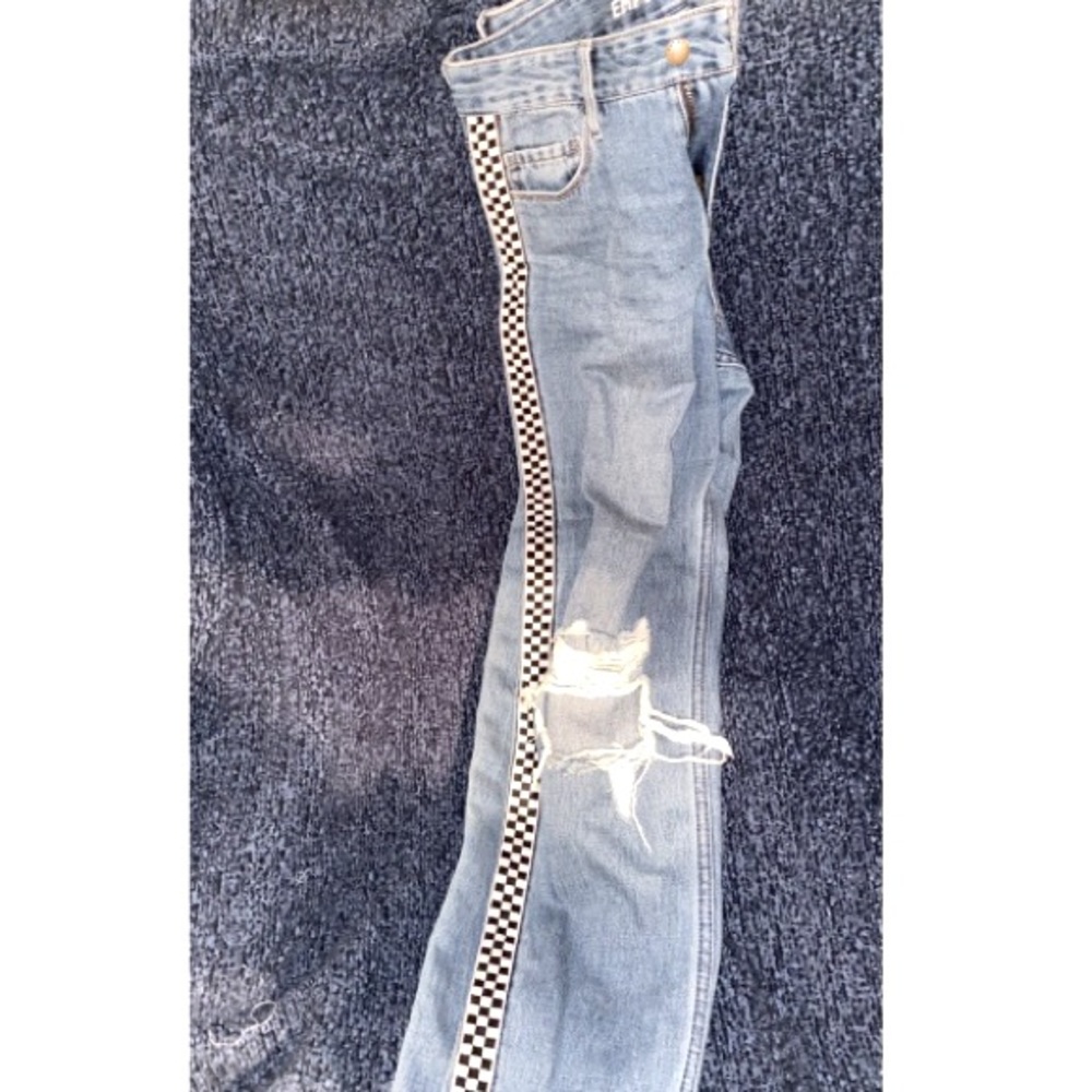 mom jeans only have a hole in each knee, and has checkered stripes on the side